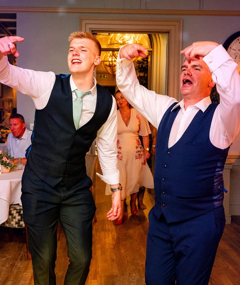 Gallery-2 Two men dancing and singing at a wedding